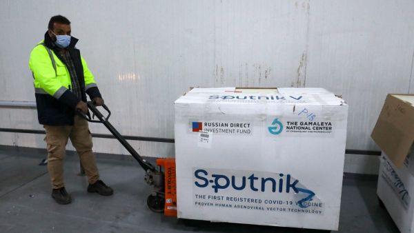 A worker handles the first batch of the Russian Sputnik V vaccine 
