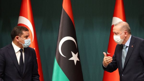 Turkish President Recep Tayyip Erdogan (R) and Libyan Government of National Unity Prime Minister Abdul Hamid Dbeibeh are seen as they attend a signing ceremony after their meeting at the Presidential Palace in Ankara, on April 12, 2021. Adem ALTAN / AFP Libyan PM’s in Ankara for 2-day talks in Turkey