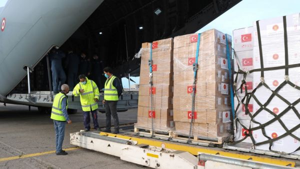 Airport personnel unload a batch of 150,000 coronavirus vaccine doses donated by Turkey, at the Mitiga airport in Libya's capital Tripoli on April 14, 2021. Mahmud TURKIA / AFP nationwide curfew in Turkey