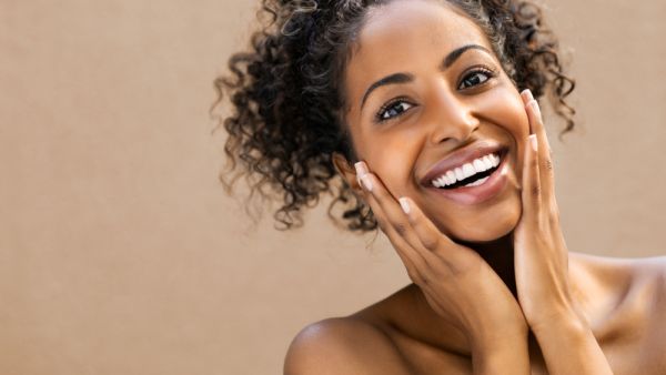 Beautiful young woman smiling after fantastic face treatment