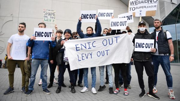 Fans hold posters reacting to the collapse of the planned creation of a European Super League, outside the Tottenham Hotspur Stadium in north London on April 21, 2021 (Photo: AFP)