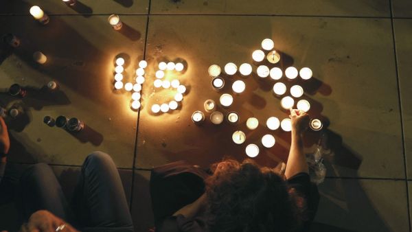 People light candles during a vigil in Habima Square in the Israeli coastal city of Tel Aviv 