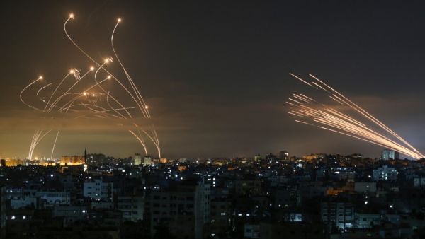 Rockets are seen in the night sky fired towards Israel from Beit Lahia in the northern Gaza Strip 