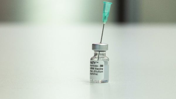A vial with the Pfizer Biontech vaccine Comirnaty stands on a table at the vaccination center of German speciality chemicals company Evonik in Hanau, western Germany, on Mai 19, 2021, amid the ongoing coronavirus (Covid-19) pandemic. THOMAS LOHNES / AFP EU signs contract to purchase up to 1.8B more BioNTech/Pfizer covid-19 jabs