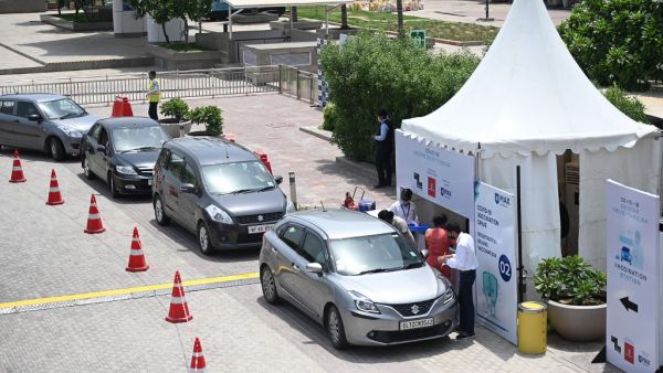 People queue in their cars to get a dose of the Covishield vaccine against the Covid-19 coronavirus, at a drive-through vaccination centre in New Delhi on May 30, 2021. Money SHARMA / AFP Over 1.84B covid-19 vaccine jabs given worldwide
