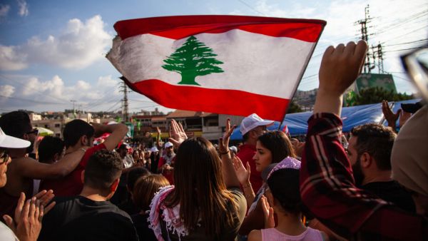 Protesters raise the Lebanese Flag