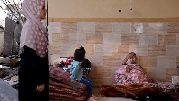 A sick child rests as other members of the Abu Ghadyan Palestinian family gather some belongings, before moving to a school run by the United Nations Relief and Works Agency for Palestine Refugees (UNRWA) where they will be living temporarily