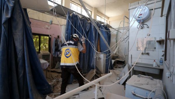 A member of Syria's Civil Defence service (White Helmets) inspects the damage on June 13, 2021, in one of the rooms of the Al-Shifaa hospital, a day after it was hit by artillery shells in the rebel-held northern Syrian city of Afrin, reportedly fired by pro-regime forces, killing at least 18 people, and wounding more than 23, according to a war monitor. The Syrian Observatory for Human Rights said a doctor, three hospital staff, two women and two children as well as a rebel commander were among the dead.  OMAR HAJ KADOUR / AFP More than a dozen people killed in Afrin missile attack.