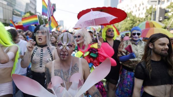 Participants march during the Warsaw Gay Pride parade in central Warsaw on June 19, 2021. 