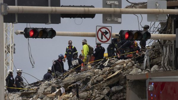 Search and Rescue teams look for possible survivors and to recover remains in the partially collapsed 12-story Champlain Towers South condo building on June 29, 2021 in Surfside, Florida.  JOE RAEDLE / GETTY IMAGES NORTH AMERICA / GETTY IMAGES VIA AFP President Joe Biden to travel to Florida later this week.