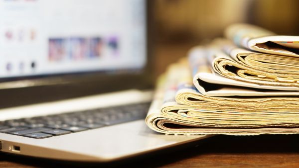 Newspapers and Laptop