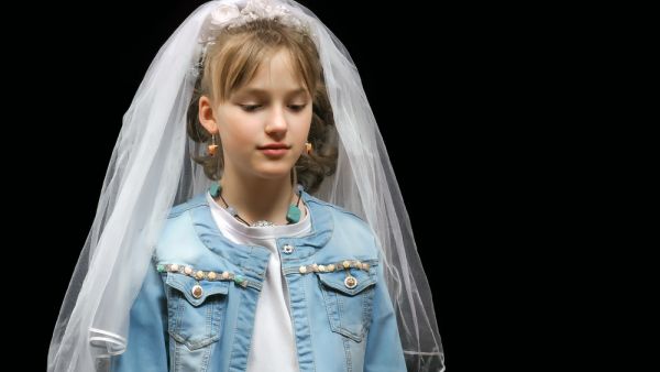 Teen girl trying on a wedding veil