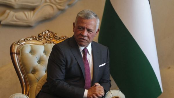 Jordanian King Abdullah II looks on as he's received by Iraq's President (unseen) at Baghdad Airport in the Iraqi capital 
