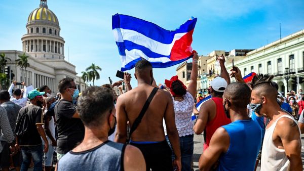 Thousands of Cubans took part in rare protests Sunday against the communist government, marching through a town chanting "Down with the dictatorship" and "We want liberty." YAMIL LAGE / AFP anti-government protests hit Cuba