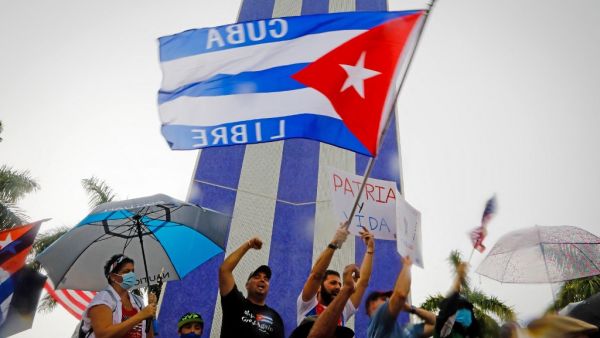 People demonstrate waving Cuban flags during a protest against the Cuban government at Tamiami Park in Miami, on July 13, 2021. Washington warned Haitians and Cubans against trying to flee to the United States as they endure domestic unrest, saying the trip is dangerous and they would be repatriated. Eva Marie UZCATEGUI / AFP Rodriguez said Washington sought to generate disorder and instability to fracture the constitutional order and social consensus in Cuba