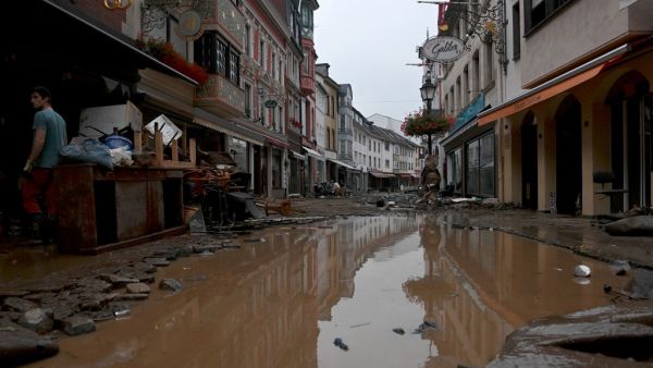 A resident stands next to damaged furnitures in a flooded street in Bad Neuenahr-Ahrweiler, western Germany, on July 15, 2021. German authorities said late July 15, 2021 that at least 58 people had likely died in massive storms and flooding in the country's west, an increase on the earlier toll of 45 dead. Christof STACHE / AFP A resident stands next to damaged furnitures in a flooded street in Bad Neuenahr-Ahrweiler, western Germany, on July 15, 2021. German authorities said late July 15, 2021 that at least 58 people had likely died in massive storms and flooding in the country's west, an increase on the earlier toll of 45 dead