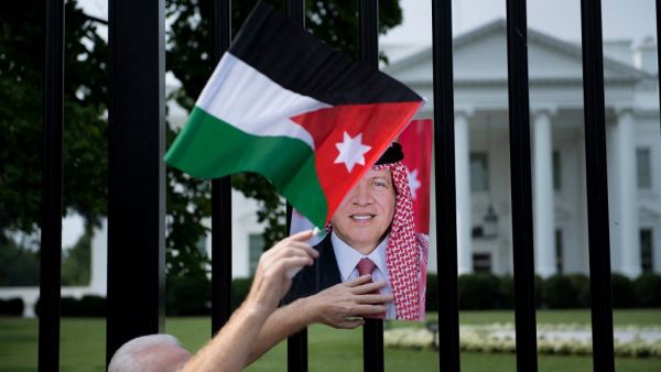 A supporter of Jordan's King Abdullah II is seen on Pennsylvania Avenue outside the White House before the leader's visit with US President Joe Biden on July 19, 2021, in Washington, DC. Brendan Smialowski / AFP Jordan King Abdullah is in Athens