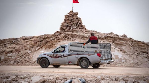 A pickup truck passes by a hilltop manned by Moroccan soldiers on a road between Morocco and Mauritania in Guerguerat located in the Western Sahara, on November 23, 2020.( AFP) The disputed territory of Western Sahara resumes between the countries.