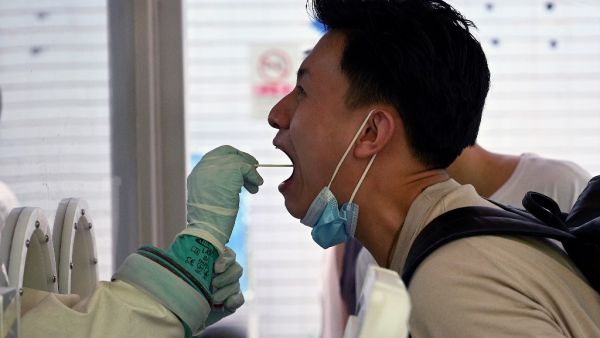 A swab sample is taken from a man to be tested for the Covid-19 coronavirus at a hospital in Beijing on August 2, 2021, amid the country's most widespread coronavirus outbreak in months. Noel Celis / AFP Lab leak theory is back on the front page by the republicans
