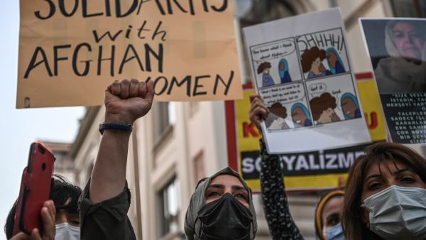 Women hold placards and shout slogans against the Taliban on August 20, 2021 in Istanbul, during a protest in solidarity to Afghan women in Afghanistan after the Taliban have taken over the country. (Photo by Ozan KOSE / AFP) Taliban fighters set woman on fire for bad cooking.