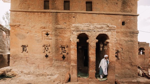  Orthodox Christian Ethiopian monk behind Lalibela church Bete Maryam Alem on May 1st. 2019 in Lalibela, Ethiopia