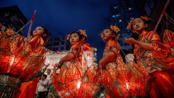Young girls with lotus lanterns take part in the annual Tai Hang "fire dragon" event, one of the highlights of the city's mid-autumn festival, in Hong Kong  
