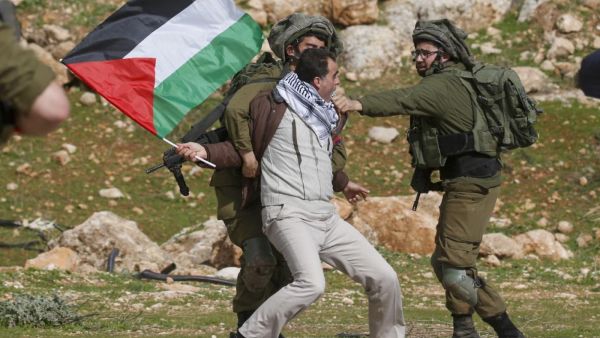 A Palestinian demonstrator detained by Israeli soldiers