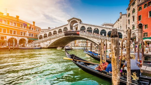 Panoramic view of famous Canal Grande from famous Rialto Bridge at sunset in Venice, Italy