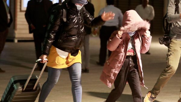 Iraqis covers her face as she arrives at the airport in Baghdad after being flown home from the Belarusian capital Minsk, on November 18, 2021. 