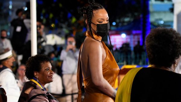 The Fenty Beauty founder chose to go braless as she rocked an orange silk dress and strappy heels. 