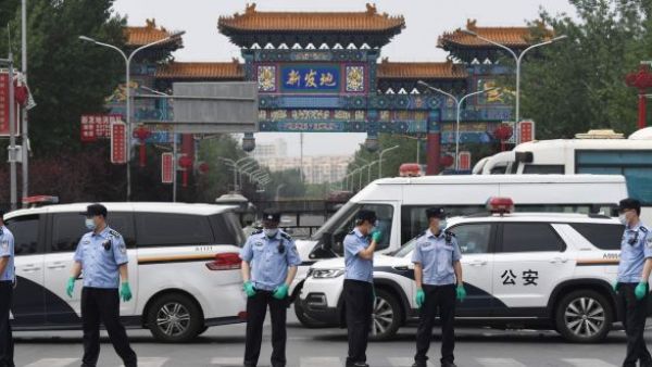 Chinese police guard the entrance to the closed Xinfadi market 