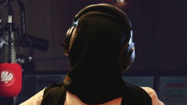 With her back to the microphone 