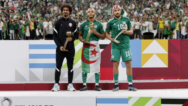 (L to R) Qatar's Akram Afif, Algeria's forward Yacine Brahimi and Algeria's forward Youcef Belaili celebrate with their bronze, golden and silver ball awards respectively during the FIFA Arab Cup 2021 final football match between Tunisia and Algeria at the Al-Bayt stadium in the Qatari city of Al-Khor on December 18, 2021. (Photo by JACK GUEZ / AFP)