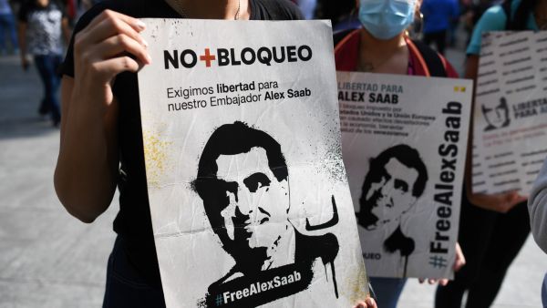 People hold signs with the image of Colombian businessman Alex Saab, who was estradited to the US, during a demonstration demanding his release, at the Bolivar square in Caracas, on October 17, 2021. Venezuela's opposition called on President Nicolas Maduro's government to resume talks to resolve their differences, after the ruling party withdrew from the latest round that was to begin Sunday in Mexico. (Photo by Federico PARRA / AFP) David Rivkin Statement on Alex Saab