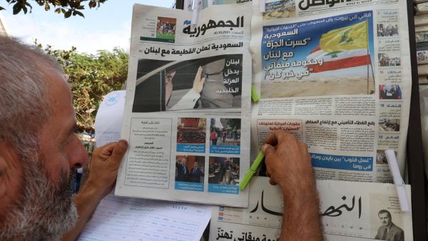 A newspaper vendor arranges newspapers, bearing headlines of the diplomatic row with Saudi Arabia, at his stall in the Lebanese capital Beirut on October 30, 2021. (Photo by ANWAR AMRO / AFP) Kuwaiti initiative proposing confidence-building measures to end a diplomatic rift with Gulf states
