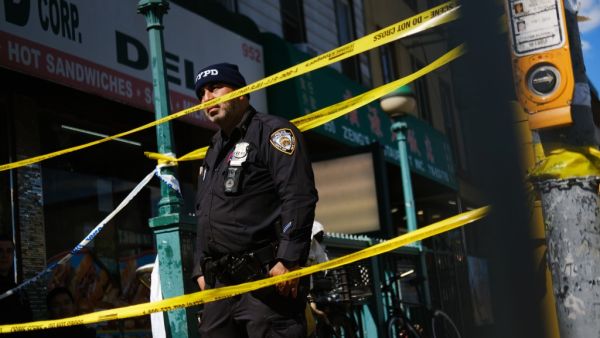 Police gather at the scene of a shooting at the 36 St subway station on April 12, 2022 in the Brooklyn borough of New York City.
