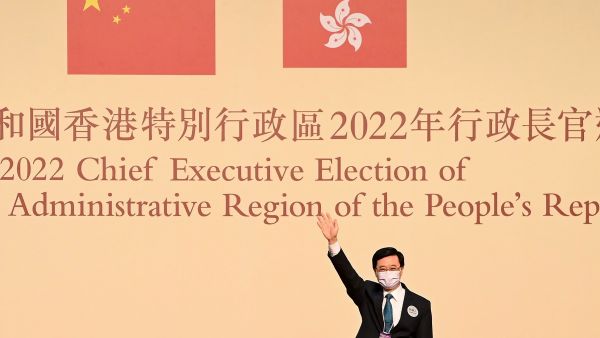 John Lee waves after becoming the city's new chief executive in Hong Kong