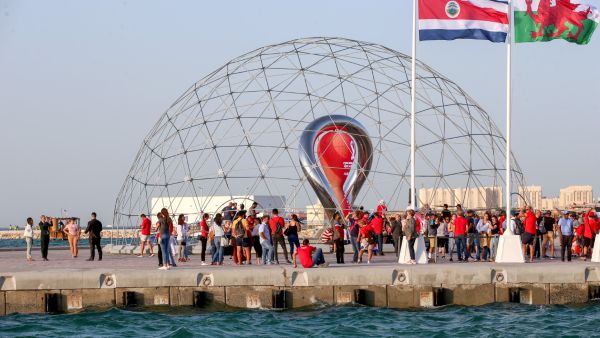 A general view shows the flags of (L to R) Costa Rica and Wales, the countries most-recently qualified for the 2022 World Cup flying with others in the Qatari capital Doha during a flag-raising ceremony of the last remaining countries to qualify, on June 16, 2022. (Photo by Mustafa ABUMUNES / AFP)