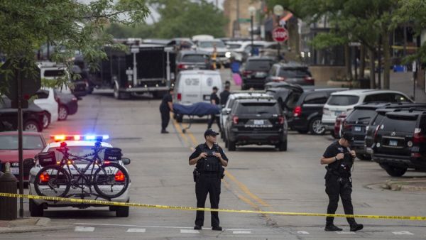 First responders take away victims from the scene of a mass shooting at a Fourth of July parade on July 4, 2022 in Highland Park, Illinois. At least six people were killed and 19 injured, according to published reports. Jim Vondruska/Getty Images/AFP Highland Park