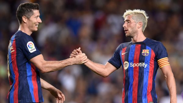 Barcelona's Spanish defender Sergi Roberto (R) celebrates with Barcelona's Polish forward Robert Lewandowski after scoring his team's fourth goal during the Spanish League football match between FC Barcelona and Real Valladolid FC at the Camp Nou stadium in Barcelona on August 28, 2022. (Photo by Josep LAGO / AFP)