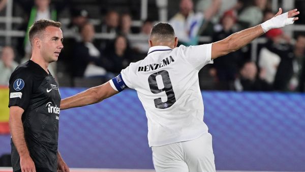 Real Madrid's French forward Karim Benzema (R) celebrates scoring the 2-0 goal in front of Frankfurt's German midfielder Mario Goetze during the UEFA Super Cup football match between Real Madrid vs Eintracht Frankfurt in Helsinki, on August 10, 2022. (Photo by JAVIER SORIANO / AFP)