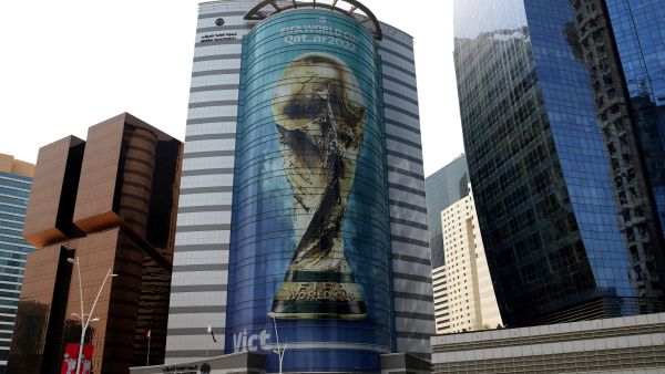 An image of the FIFA 2022 World Cup trophy adorns a building in the Qatari capital Doha on August 16, 2022. (Photo by Mustafa ABUMUNES / AFP)