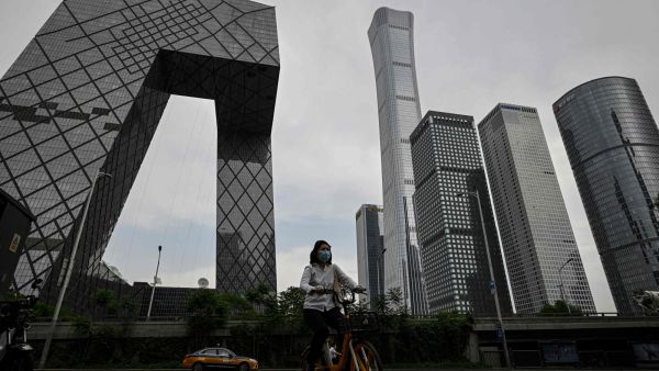 A women cycling in Beijing's business district 