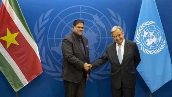 Suriname President Chandrikapersad Santokhil shakes hands with United Nations Secretary General Antonio Guterres at the UN headquarters in New York, September 18, 2022, during the 77th session of the UN General Assembly. (Photo by Craig Ruttle / POOL / AFP) United Nations