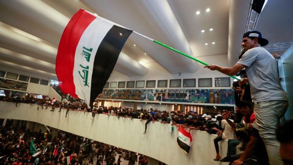 Al Sadr supporter waves flag inside Iraqi Parliament 