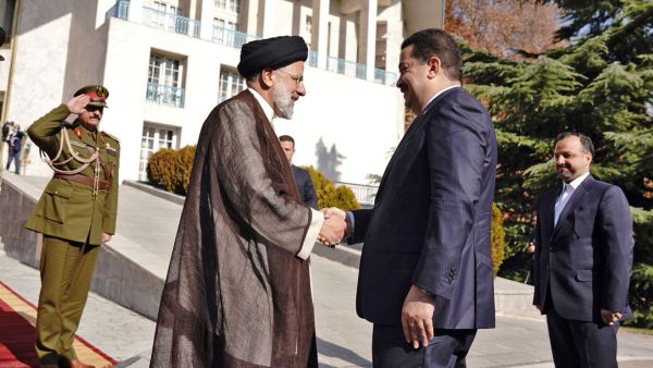 Raisi (L) receives Sudani 