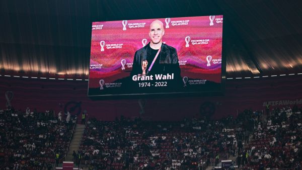 A giant screen displays a photo of U.S. journalist Grant Wahl who died after he collapsed in the stadium's press area while covering the match between Argentina and Netherlands. (Photo by GABRIEL BOUYS / AFP) U.S. journalist Grant Wahl