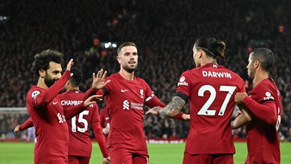 Liverpool's teammates celebrate the second owngoal scored by Leicester City's Belgian defender Wout Faes during the English Premier League football match between Liverpool and Leicester City at Anfield in Liverpool, north west England on December 30, 2022. (Photo by Oli SCARFF / AFP) 