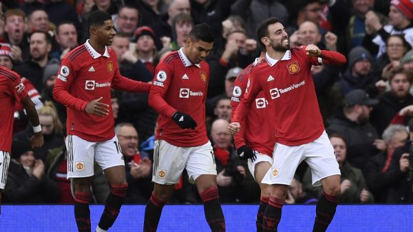 Manchester United's English striker Marcus Rashford (L) congratulates Manchester United's Portuguese midfielder Bruno Fernandes (R) on his goal during the English Premier League football match between Manchester United and Manchester City at Old Trafford in Manchester, north west England, on January 14, 2023. (Photo by Oli SCARFF / AFP)