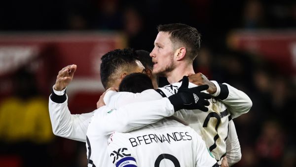 Manchester United's Dutch striker Wout Weghorst (C) celebrates with teammates after scoring his team second goal during the English League Cup semi-final first-leg football match between Nottingham Forest and Manchester United, at The City Ground stadium, in Nottingham, central England, on January 25, 2023. (Photo by Darren Staples / AFP)